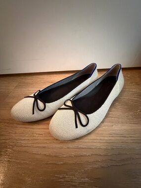Rothy's Cream Ballet Flats with Black Trim and Bow Accent